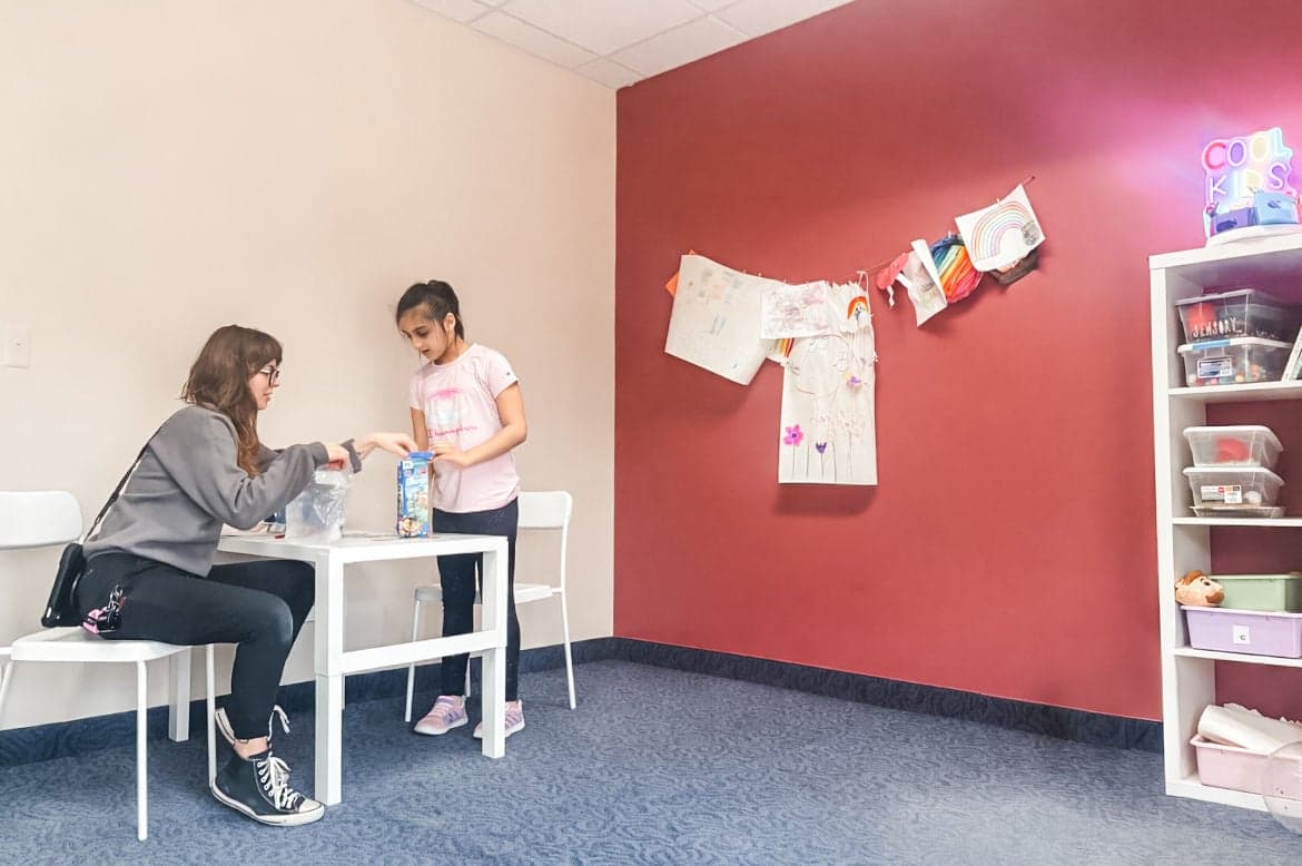 ABA room with therapist and child at table