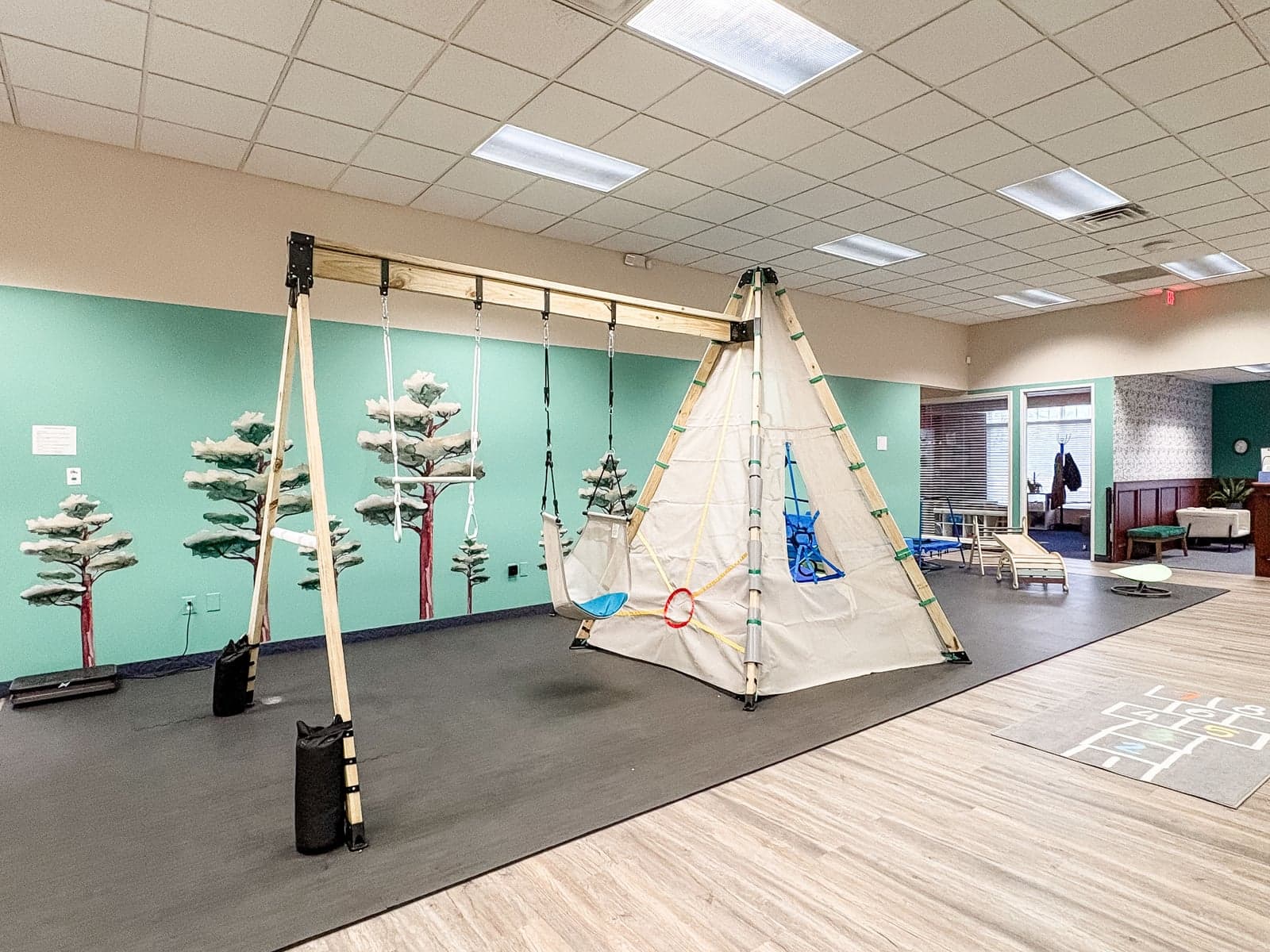Gym with swings and mural