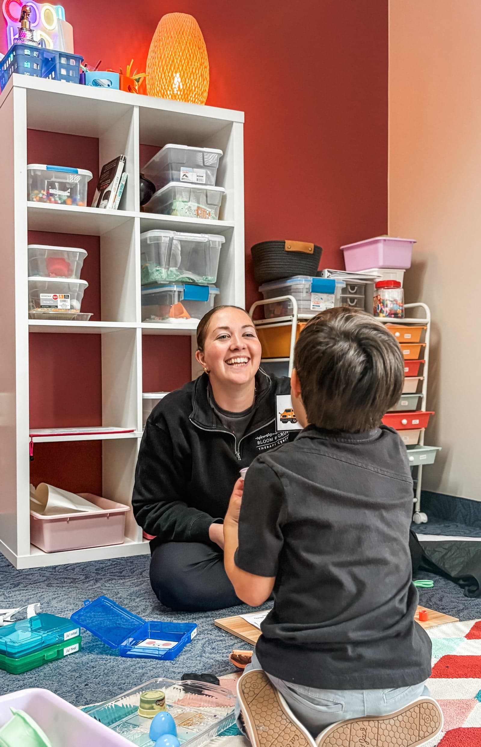 Therapist working with child in ABA therapy room