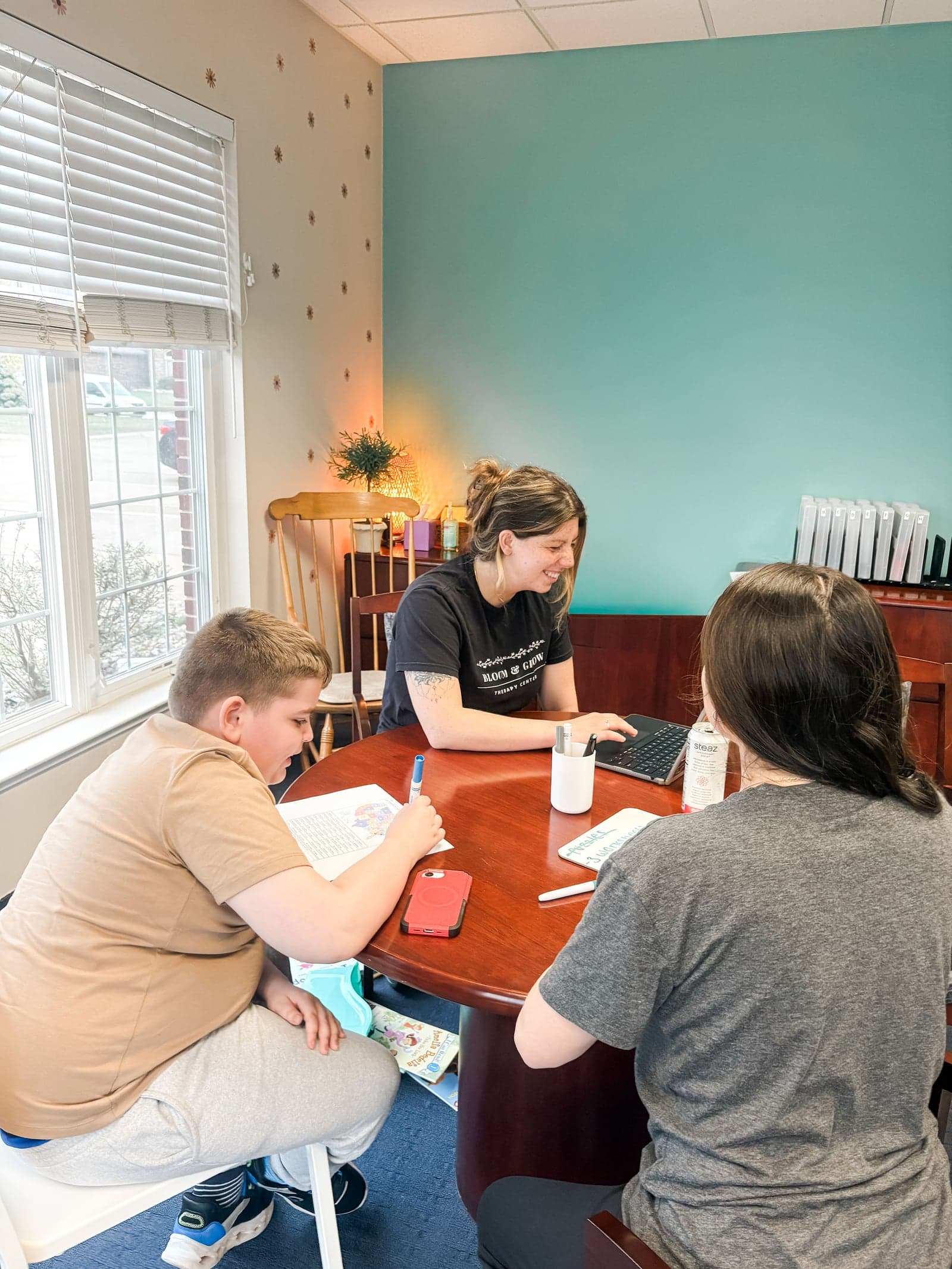 Parent consultation meeting with therapist at table